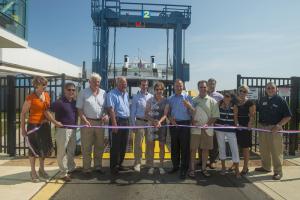 Shown during the ribbon cutting ceremony are (l-r) Betsy Reamer, executive director, Lewes Chamber of Commerce; Heath Gehrke, director of ferry operations; Ted Becker, deputy Lewes mayor; Rick Downes, commisioner, Delaware River & Bay Authority; Bill Lowe, vice chairman DRBA; Teresa Ford, wife of Lewes mayor; Gov. Jack Markell; Jim Ford, Lewes mayor; Scott Green, executive director, DRBA; Nickky Fisher, Lewes Chamber of Commerce Board member and ferry terminal manager; Jennifer Joseph, Lewes Chamber of Commerce board member; Orville Mills, Lewes Chamber of Commerce board member. BY DENY HOWETH