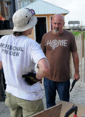 Northbeach owner John Snow, right, gets safety advice from Zambelli International pyro Cynthia Ferguson. BY DAN COOK