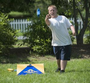 Willy McCabe of Harbeson plays a bag toss game provided by THe Endeavor Masonic Lodge 17 during Milton's July 4th celebration BY DENY HOWETH