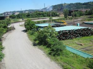 Miles and miles of natural gas pipeline are stockpiled along the railroad tracks near Pittsburgh, earmarked to eventually transport natural gas from the Marcellus shale formations in western Pennsylvania and Ohio to the processing and distribution facilities in Texas. Mike speculated that the pipe could be manufactured with steel from the Edgar Thompson Works, shown here in the background.