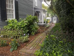 At the Jim Prettyman/Adkins-Draper House, a shaded brick path leads to the garden that overlooks a view of Wagamons Pond. BY DENY HOWETH