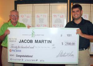 Steve Lett presents a $2,500 scholarship check to Jacob Martin of Ocean View. Martin, an Indian River High grad, received the check after the charity golf tournament held for the fund at Kings Creek Country Club July 19. SOURCE SUBMITTED