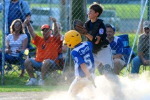 Camden Trayer scores a run for Woodbridge in the second inning as Hunter Rauch awaits a throw. BY DAVE FREDERICK