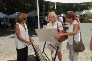 Artist Margie Beacham, left, talks with Lorraine Zellers, center, and Carol Popham about her watercolor prints.