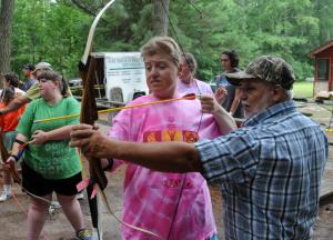 Special Olympics athlete Kendra Surin of Ocean City draws her bow and focuses on the target as volunteer Tinker Severson of the 4-H Shooting Sports Program teaches the art of archery. BY DAN COOK