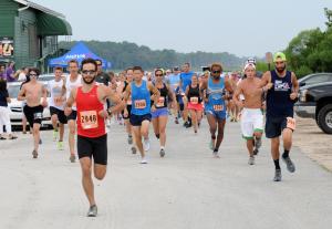 Radley Reist, left, shoots out fast and never looks back. He won the Buddy Run 5K with a time of 17:13.3. BY DAN COOK