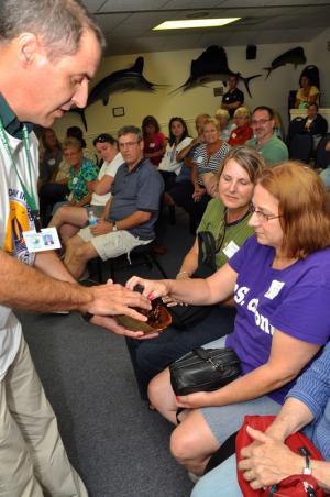 Teachers get up close and personal with a horseshoe crab during a presentation by Richard Julian, Cape Henlopen State Park's interpretive manager. BY RON MACARTHUR