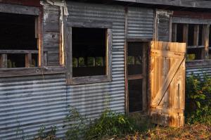 The late-afternoon sun lights up one of several doors on the large chicken house on the Smith family farm. It was in use for about 50 years. BY RON MACARTHUR