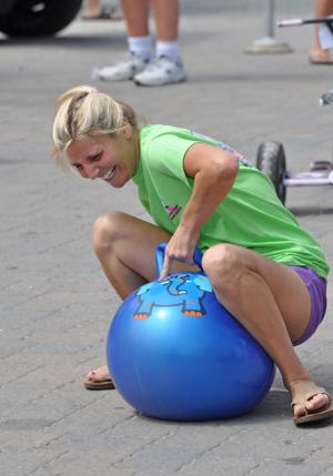Kristen Frederico of Dewey Beach slips off the bouncy ball during her run in the obstacle course. BY NICK ROTH