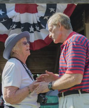Barbara Vaughn, former Lewes city councilwoman, greets Sen. Tom Carper at the Democratic Jamboree. BY DENY HOWETH