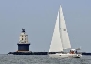 Delgato passes by the Harbor of Refuge Lighthouse heading into Delaware Bay after an ocean crossing from the start at Cape May, N.J. BY RON MACARTHUR