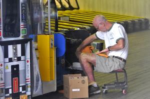 Re-supplying tickets is also a daily job. Craig Fasnacht, electronics specialist, puts a new roll in a machine. BY RON MACARTHUR
