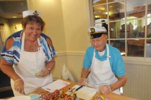 Kelly Novak, Heritage activities director, and Herman Schmidt work on their nautical cupcakes on the way to winning Best Theme.