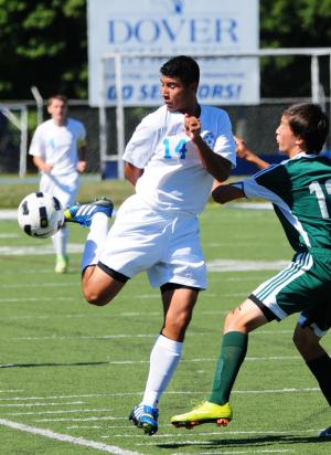 Cape senior forward Miguel Merino-Sanchez kips the ball up to move past a Hillers defender. BY DAN COOK