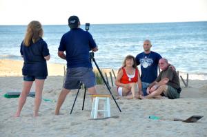 As a momento of their say at the beach, a family poses for a photograph along the shoreline. BY RON MACARTHUR