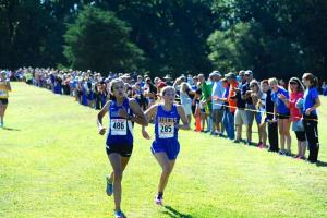 Rebekah Mills of CR outsprints Caroline Subramoney to the finish line. Mills placed third in the field of high school runners. BY DAVE FREDERICK