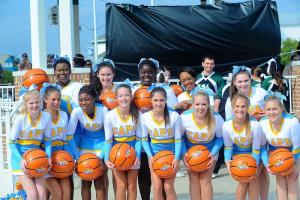 Cape cheerleaders are ready to throw balls into the crowd at the Slam Dunk announcement. Shown are in back (l-r) Mari Horsey, Liz Sparks, Mozella Matthews, Brittney Harris, and Shanna Farlow. In front are Jessica Melson, Havannah Nunez, Aleeya Wynder, Bryn Tompkins, Paige Fleegle, Sara Lingo, Molly Smith, and Cheyenne Clarke. BY DAVE FREDERICK