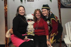Getting the holiday event started right with Santa are Terra Dillon, left, Katie Landon and Elf Julia Walls. BY STEVEN BILLUPS