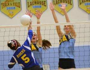 Frontline blockers Alison Palmer, left, and Megan Hart block a kill attempt by Caesar Rodney's Camille Lecompte. BY DAN COOK