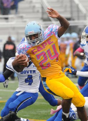 Cape senior running back Andre Flowers spins and runs through the Dover defensive backfield for a long gain. BY DAN COOK