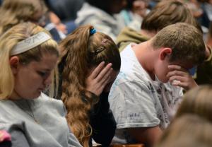 Students close their eyes and reflect on their lives during the Rachel's Challenge presentation. BY DAN COOK