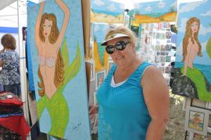 Artist Constance Guerra of Midland, Va., shows off her colorful beach-themed artwork as one of dozens participating in the Lewes Histocial Society's craft fair. "This is a special place for me," she said about Lewes. BY RON MACARTHUR