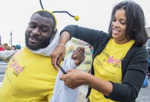 Team Bumble Glee Hive gets dressed for the walk. Jordan Thomas gets a hand with his wings from Jessica Dubois. BY DENY HOWETH
