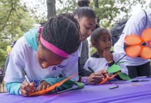 Shown (l-r) Marley, Daisha and Kailani Summers choose Promise Flowers to represent their connection to the disease. BY DENY HOWETH