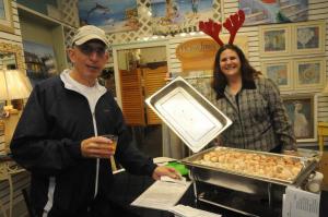 Inside of Treasures, Christine Conn from JD’s Café was serving up scallops wrapped in bacon. Ready for a second taste is Fred Minasian from Milton. BY STEVEN BILLUPS