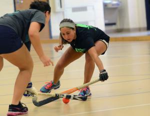 Former Milford High School all-star Sara Kolobielski blocks up a Kelly Smith pass attempt. BY DAN COOK