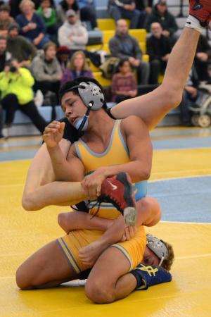 Cape's Elliott Young gets tangled up with Tech's Matt Wilson and falls to the Ravens' 138-pounder 12-0. BY DAN COOK