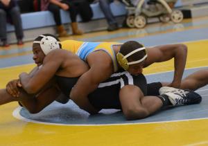Tech's Dimarco Dorsey holds on for dear life but falls to Cape's J.J. Currie in a 12-4 major decision at 152. BY DAN COOK