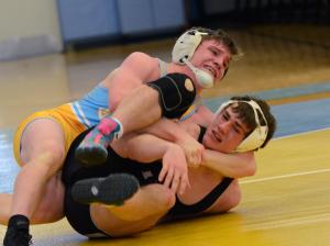 Austin Smith works for a 17-0 tech fall over Tech's Colin Bergh in the 160 weight class. BY DAN COOK