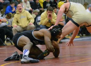 Cape's Andre Flowers grapples Sallies' Daulton Gregory but loses 3-1 in the 182-pound class. BY DAN COOK