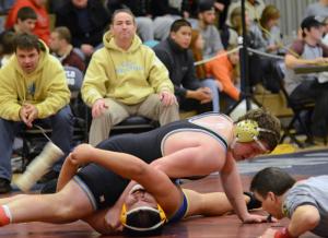 Cape's Nick Carroll works for the 7-1 semifinal win over Sussex Central's Victor Cruz in the 220-pound weight class. BY DAN COOK