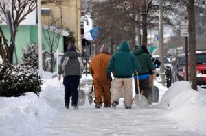 A shoveling crew heads for their warm truck after finishing a job in Rehoboth Beach. BY RON MACARTHUR