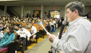 Sarah Ross reads a question to the contestants while the fourth- and fifth-grade students support their classmates. BY DENY HOWETH