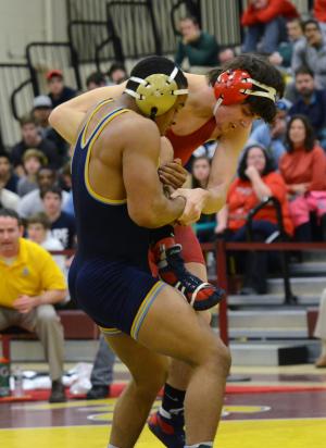Justin Lopez wins the Henlopen Conference Championship in the 170-pound class with a 9-4 decision over Ronnie Wuest of Smyrna. BY DAN COOK