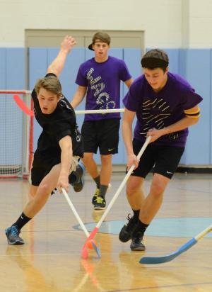 Ugly Pucklings' Chris Argo, left, battles with team Riley Wagner's Drew Mulcahy as Kai Vitella looks on. BY DAN COOK