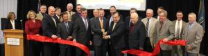 A large group of Delaware Technical Community College officials, elected representatives, family members and friends gather around Delaware Gov. Jack Markell and Del Tech President Orlando J. George Jr. as they cut the ribbon to officially open the new Theodore C. Freeman Powerplant Education Building. BY DENNIS FORNEY