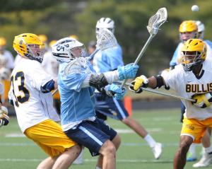 Cape senior attackman Luke Benson takes a shot through a Bullis stick check. Benson had two goals and two assists in the 10-6 loss to the Maryland powerhouse. BY DAN COOK