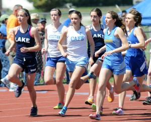Cape's Madison MacElrevey, center, keeps pace with the field, but turns it on to finish second in the 1,600 with a time of 5:39.4. BY DAN COOK