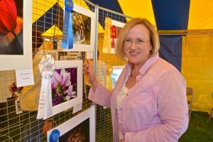 Leslie Lesko shows off her grand-prize winning photograph in the annual Tulip Festival photography contest. BY RON MACARTHUR
