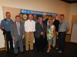 Many officials concerned with alcohol service and enforcement attended the event. Pictured in the back row (left to right) are Dewey Beach Sgt. Cliff Dempsey, Alcohol and Tobacco Enforcement Lt. Kevin Jones, Dewey Beach Lt. Bill Hocker, HERO Campaign founder Bill Elliott, NKS Distributors Executive Vice President Paul Ruggiero and Starboard owner Steven Montgomery. In the front row are Delaware Alcoholic Beverage Control Commissioner John Cordrey, NKS Distributors representative Bobby Tigani Jr., Delaware State Fire Marshals Office Chief Deputy Harry Miller and Delaware Restaurant Association President Carrie Leishman. BY CHRIS FLOOD
