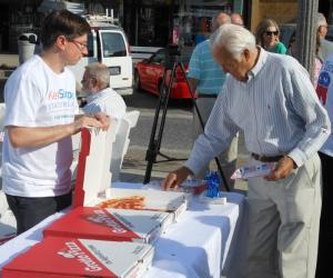A Rehoboth Beach native, Simpler has the support of both Grotto Pizza and Nicola Pizza. Here Dewey Beach resident Ben Carr gets a slice of pizza from Jesse Grove. BY CHRIS FLOOD