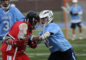 Cape middie Sean Lally, right, plays close defense on a Panthers midfielder. Lally scored twice for the Vikings. BY DAN COOK