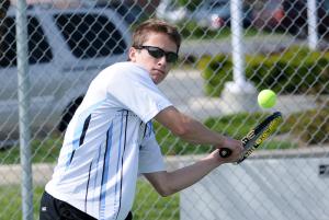 Cape first singles player Ryan Thornburg prepares to hit a heavy topspin backhand in the 6-0, 6-0 win over Polytech's Will Lackey. BY DAN COOK