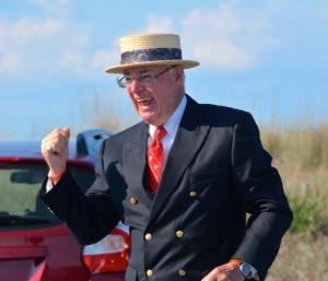 Ned Maull reacts after a successful first firing of his cannon during a May 24 ceremony. BY RON MACARTHUR