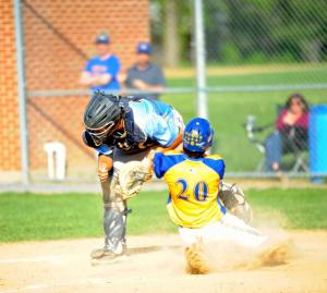 The Riders' Seth Brosius slides into a single-leg takedown of catcher David Kwan, who does not have the ball. The ruling was "runner safe." BY DAVE FREDERICK