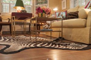 The den by Mark Showell Interiors was inspired by former owner Clem Conger to represent a formal yet comfortable setting to entertain. BY DENY HOWETH